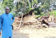 Odukpani Community raises alarm as murder suspect’s brother, arrested with gun, is not transferred to Calabar Village Head of Ukim Ita Eyo Ndem Community, Chief Samuel Ekpe-Ita, standing in front of the murder suspect's (Akaniyene Ignatius Eshiet), a destroyed property